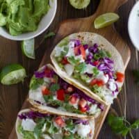 overhead view of 3 Baja Fish Tacos on a cutting board