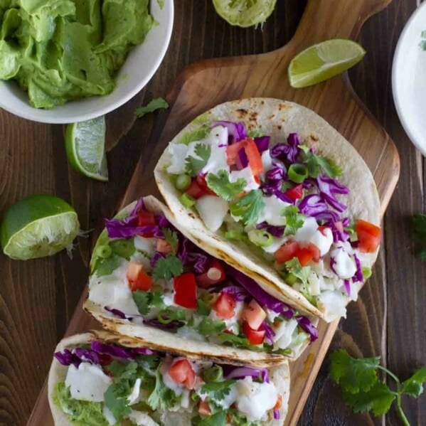 overhead view of 3 Baja Fish Tacos on a cutting board