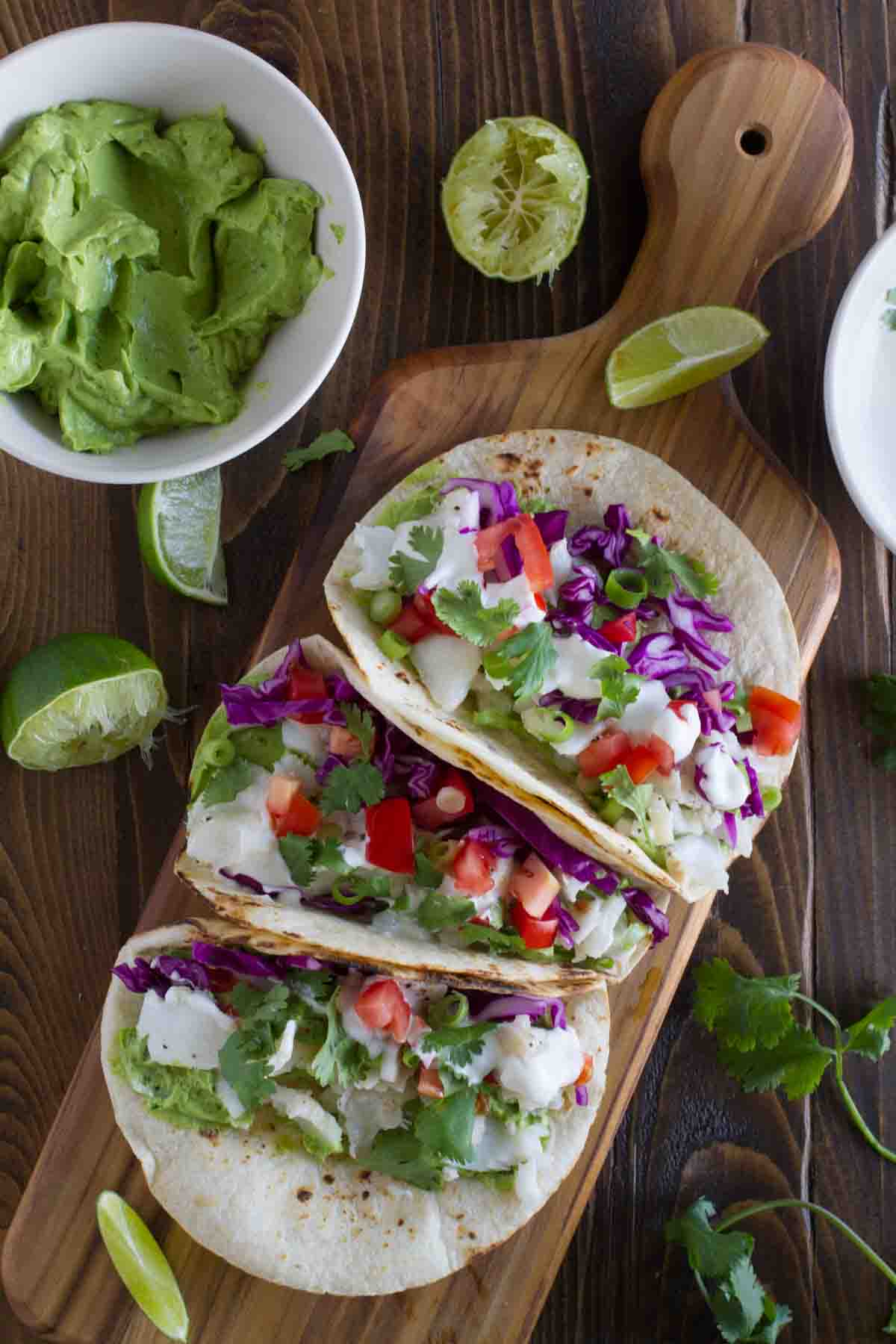 overhead view of 3 Baja Fish Tacos on a cutting board