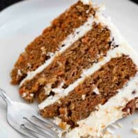slice of layered carrot cake on a plate showing texture