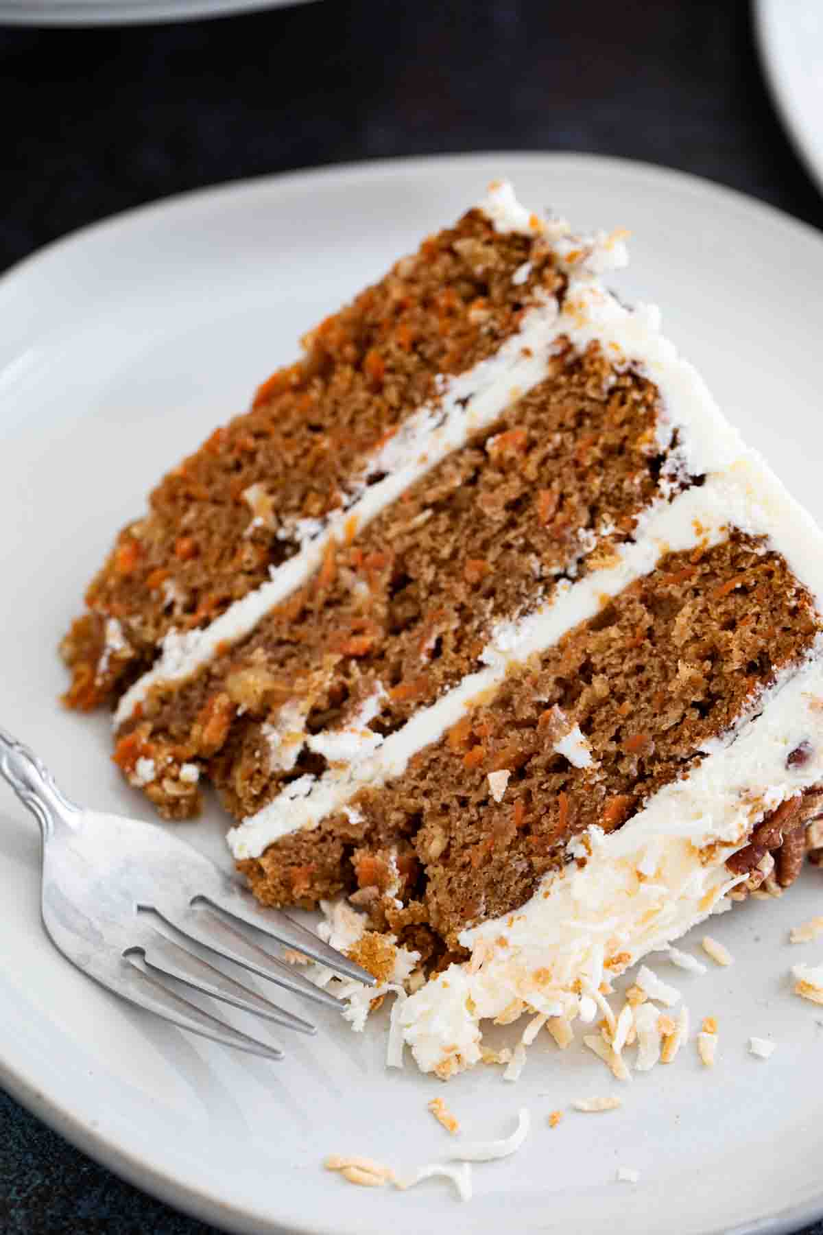 slice of layered carrot cake on a plate showing texture