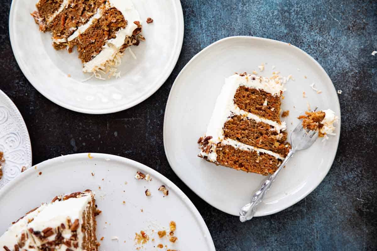 overhead view of plates of carrot cake with frosting