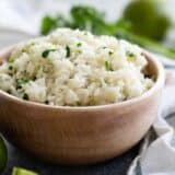bowl of cilantro lime rice in a wooden bowl
