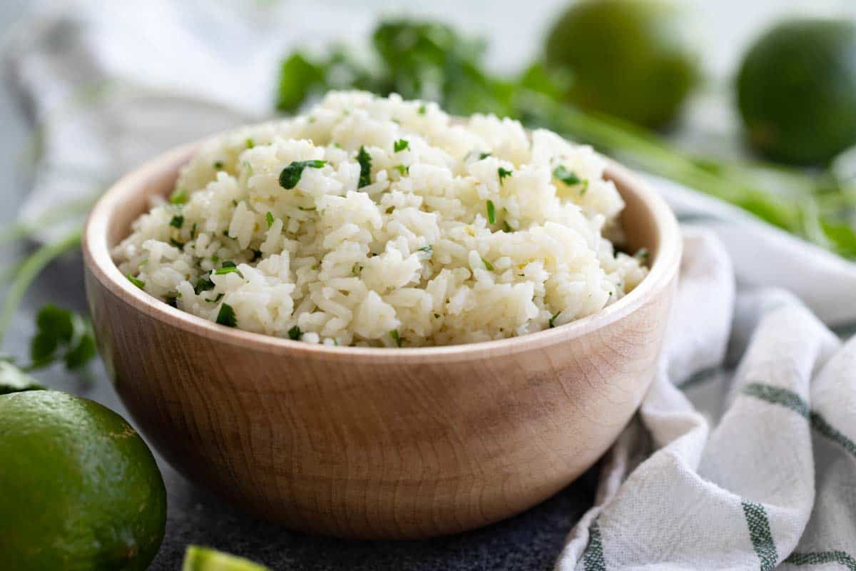 bowl of cilantro lime rice in a wooden bowl