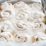 pan full of cinnamon rolls with icing