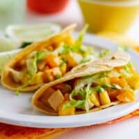 2 Citrus Fish Tacos on a plate with lime slices