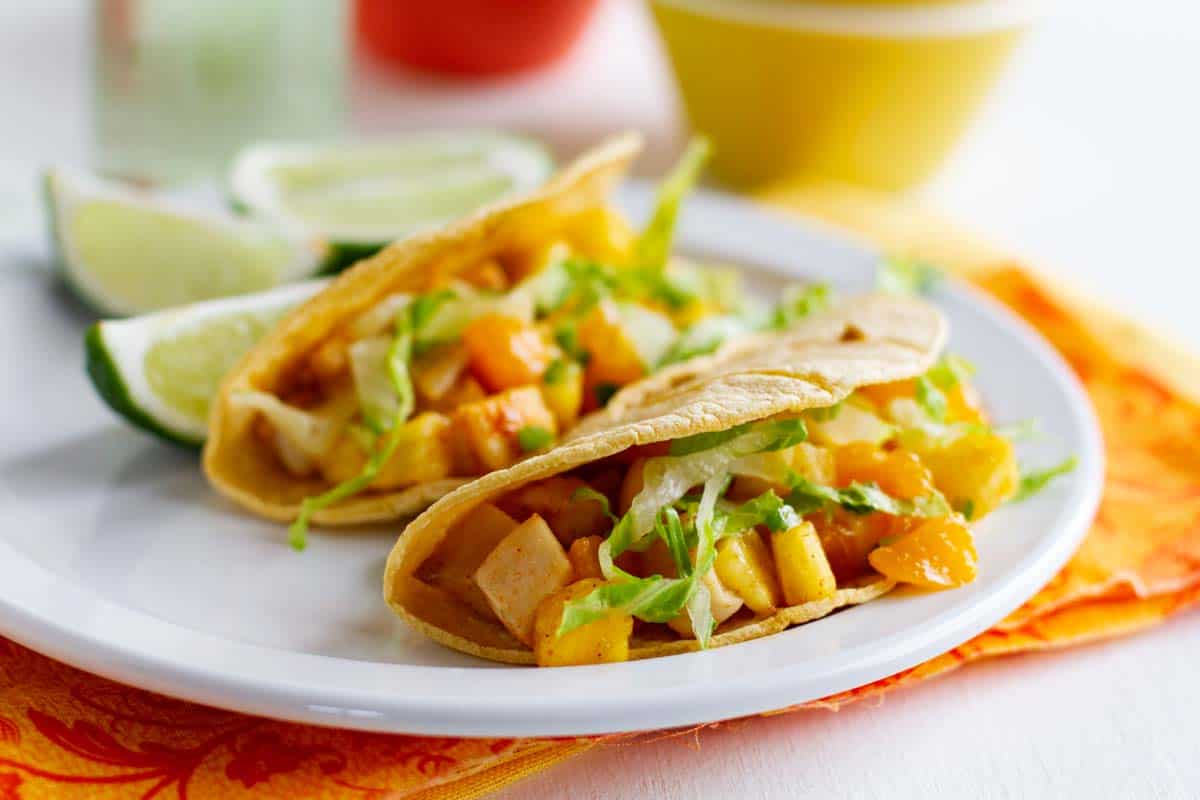2 Citrus Fish Tacos on a plate with lime slices
