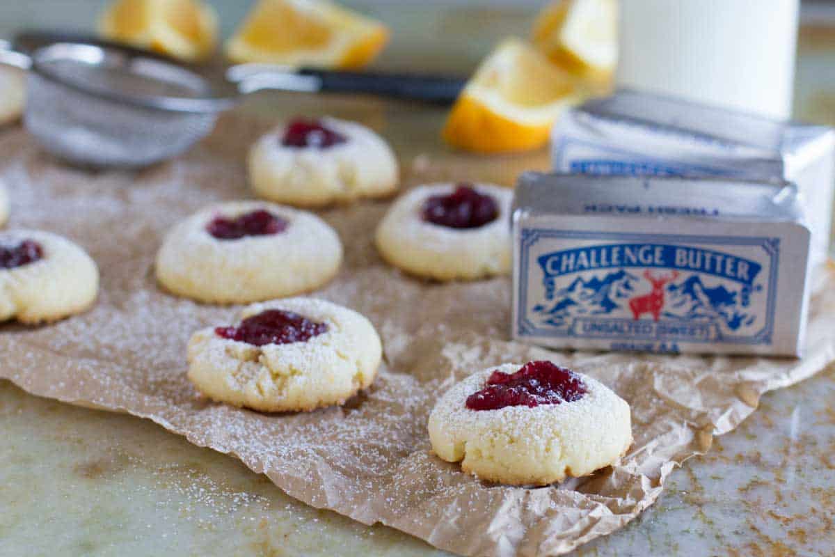 Orange scented cookies are topped with a dollop of cranberry sauce in these festive Cranberry Thumbprint Cookies. Cranberry filled thumbprint cookies