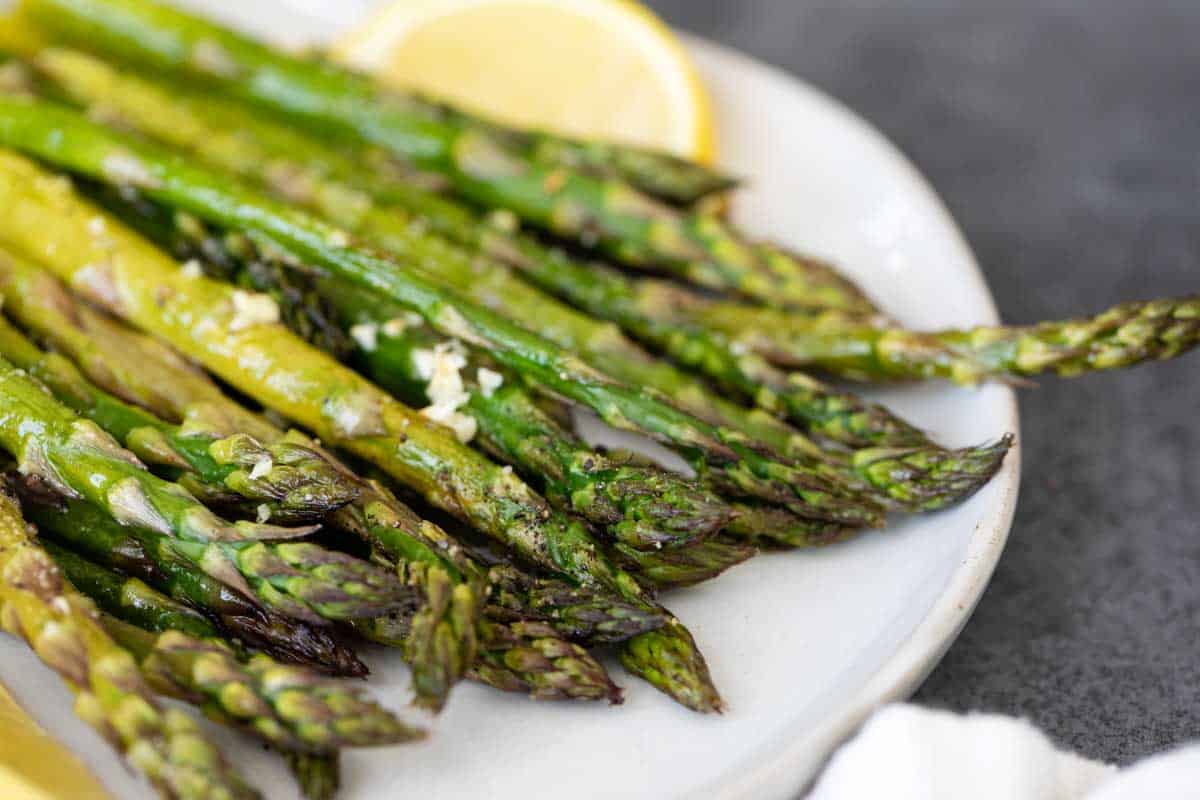 roasted asparagus on a plate with lemon slice