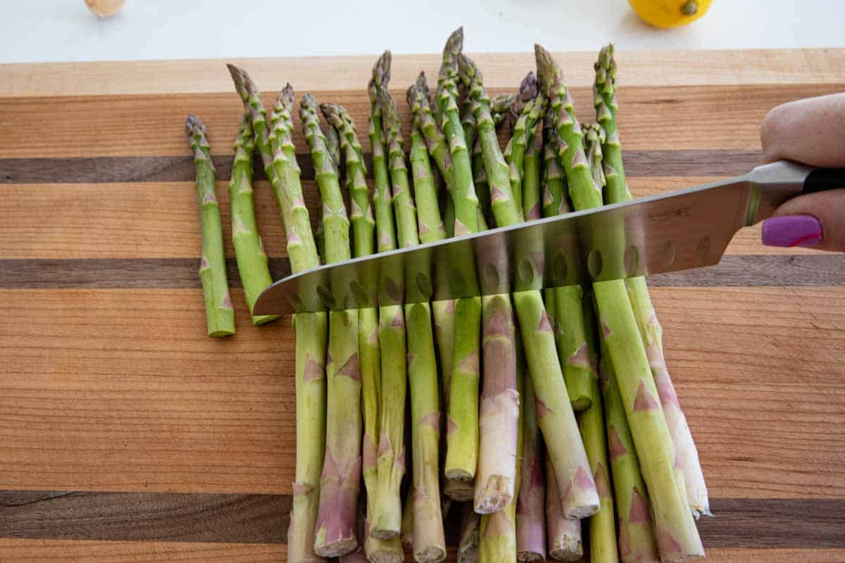 slicing the ends off of asparagus