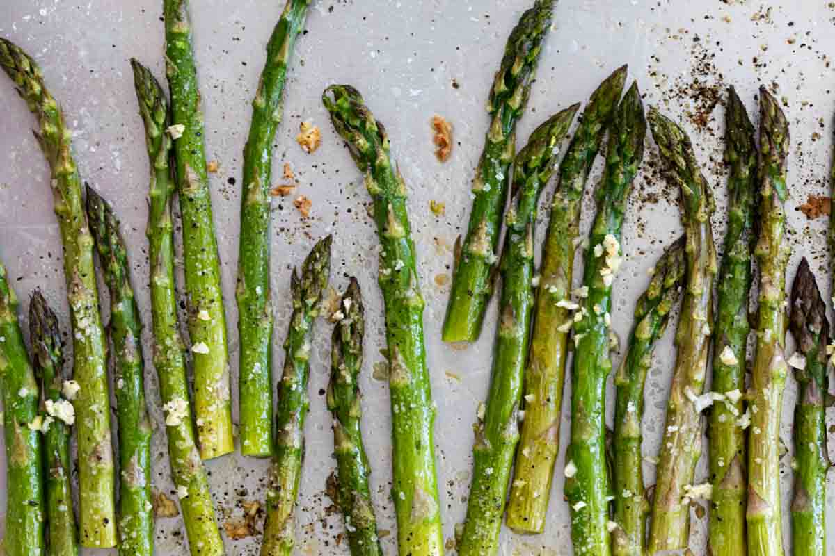 roasted asparagus with garlic on a baking sheet
