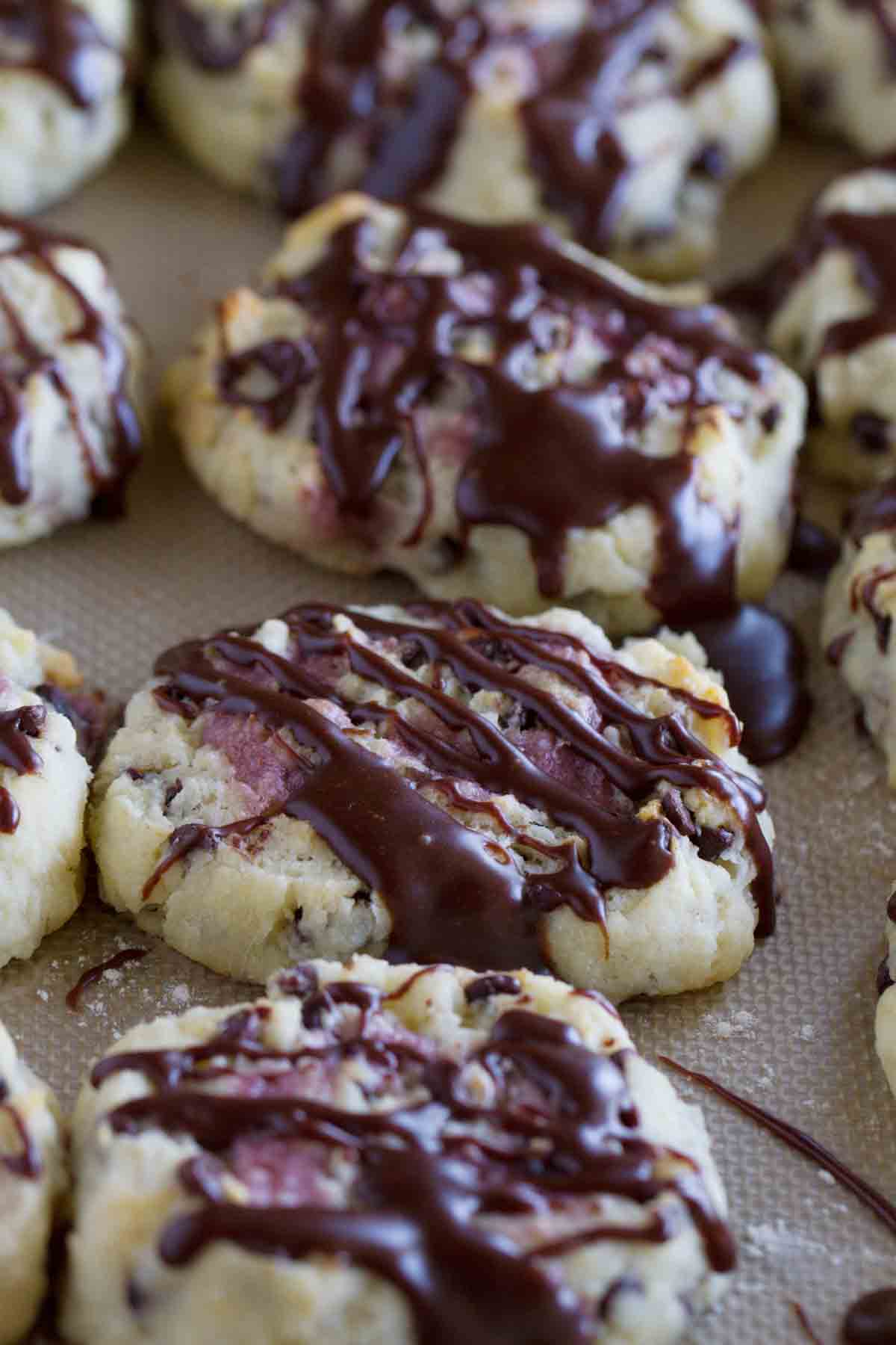 chocolate chip biscuits with raspberry cream with a chocolate drizzle
