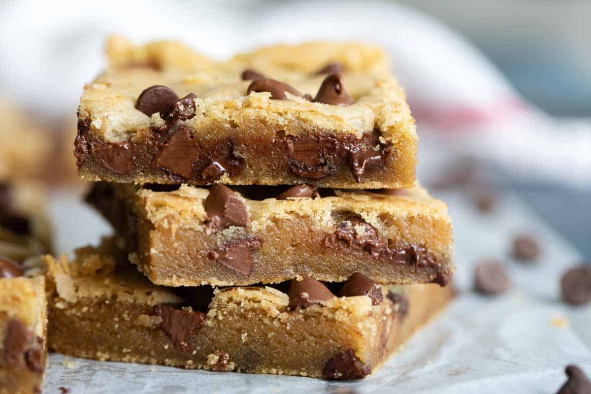These Chocolate Chip Cookie Bars are soft, moist and addictive. Made with oil instead of butter, they stay nice and tender. cut cookie bars showing moist texture
