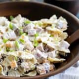 bowl with pasta salad with ingredients in the back