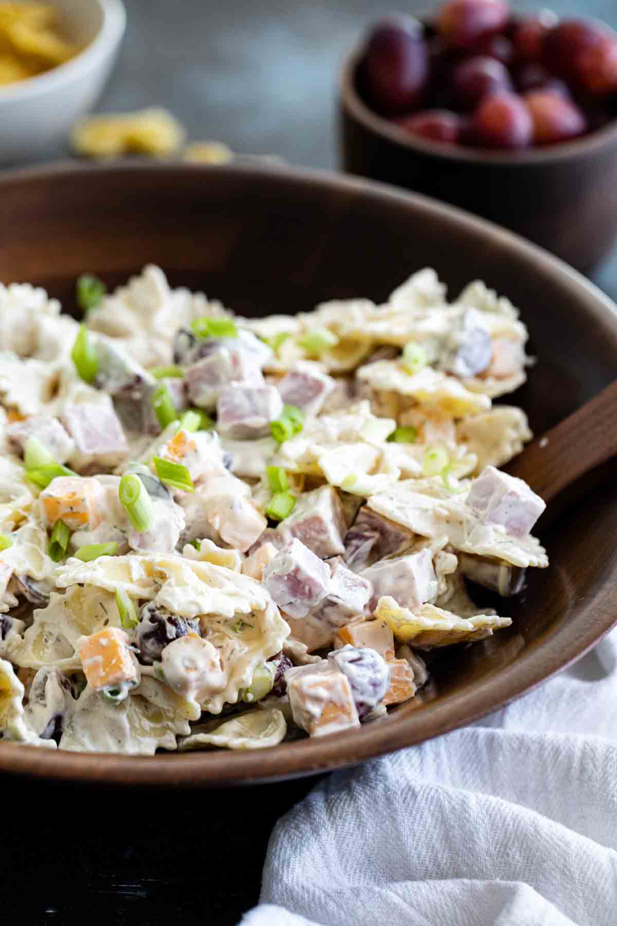 bowl with pasta salad with ingredients in the back