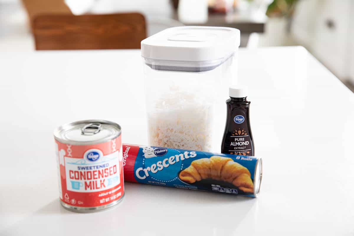4 ingredients for coconut bars - coconut, almond extract, crescent rolls, sweetened condensed milk