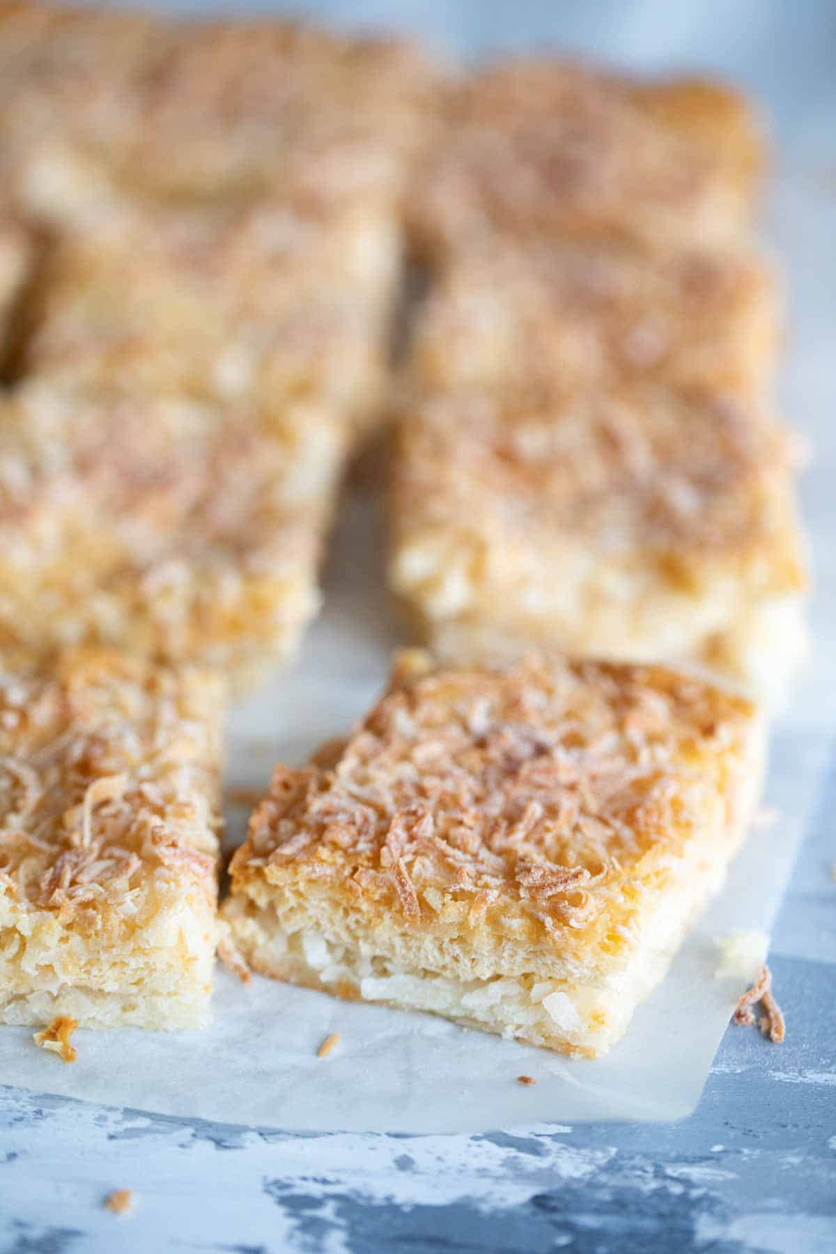 cut coconut bars on a piece of parchment paper