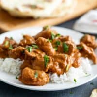 Butter Chicken over rice on a plate