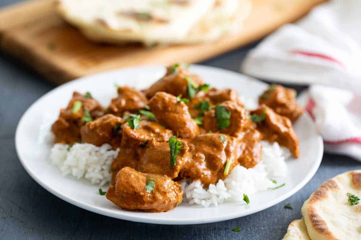 Butter Chicken over rice on a plate