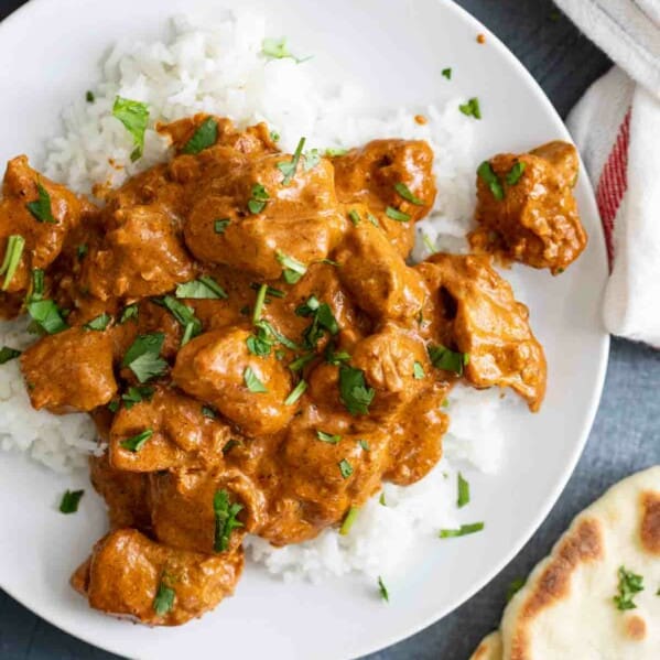 overhead view of Butter Chicken over rice with naan