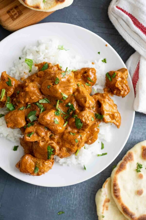 overhead view of Butter Chicken over rice with naan