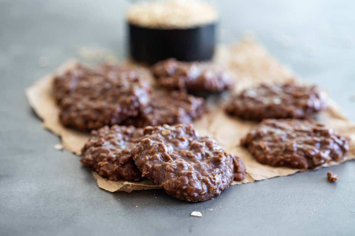 Turn off the oven and make these No Bake Cookies that are made with oats, peanut butter and cocoa. These cookies are great during the summer when you want to keep things cool, and they are also great for cooking with kids. chocolate no bake cookies on brown paper