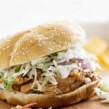 Slow Cooker Teriyaki Chicken Sandwich on a cutting board