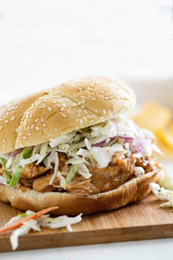 Slow Cooker Teriyaki Chicken Sandwich on a cutting board