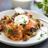 taco casserole on a white plate with a fork