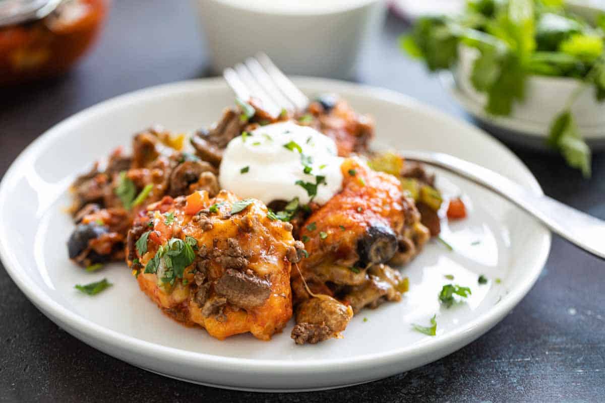 taco casserole on a white plate with a fork