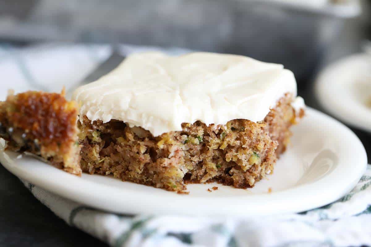 slice of zucchini cake with a bite taken from it