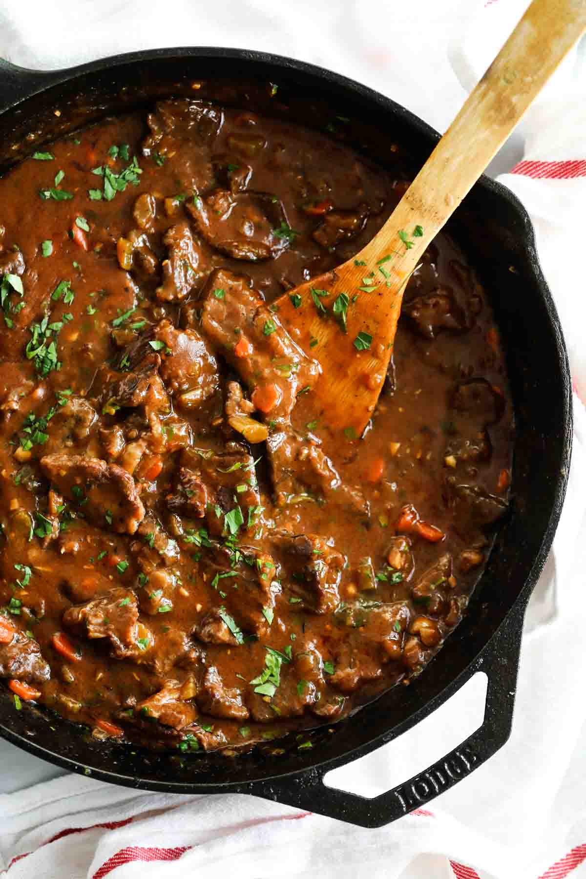 overhead view of beef tips and gravy in a cast iron pan