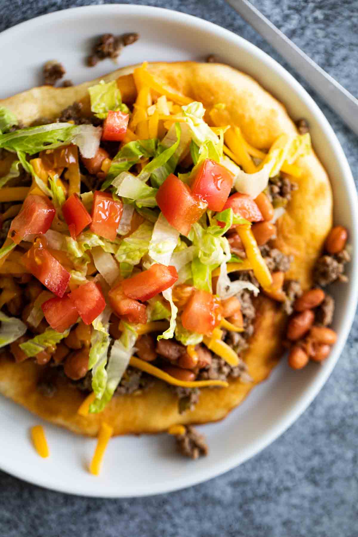 overhead view of navajo taco topped with toppings