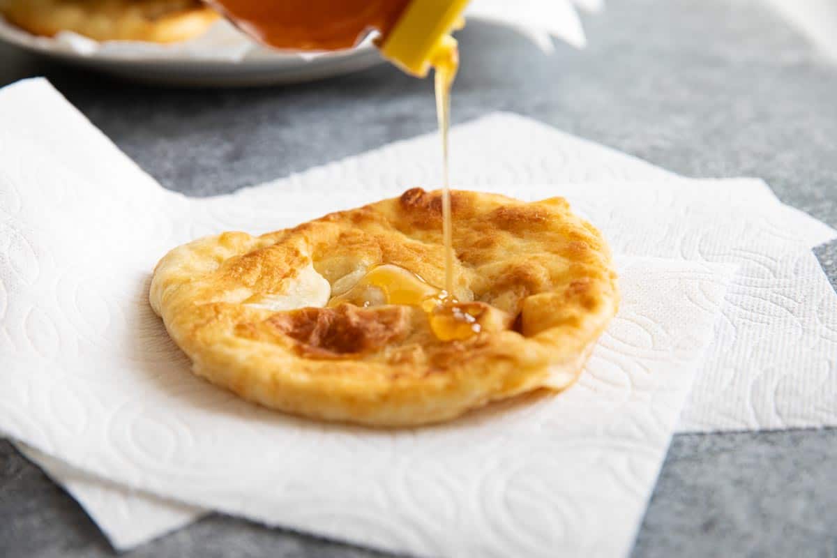 fry bread being topped with honey