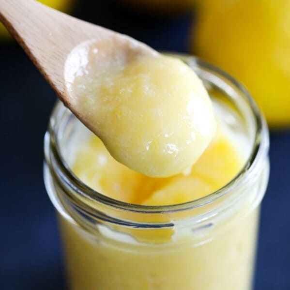 wooden spoon dipped in lemon curd