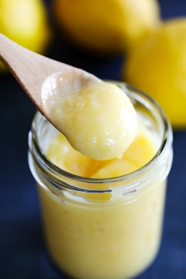 wooden spoon dipped in lemon curd