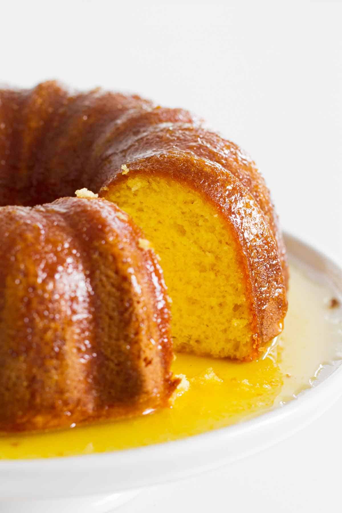 full orange bundt cake with a slice removed