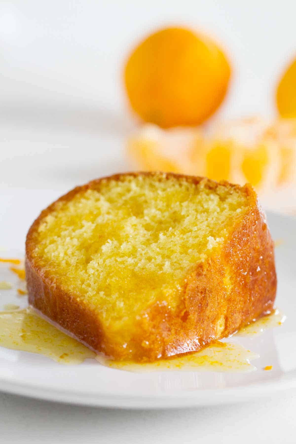 slice of orange cake on a plate with glaze