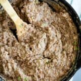 overhead view of refried beans in a cast iron skillet