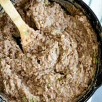 overhead view of refried beans in a cast iron skillet