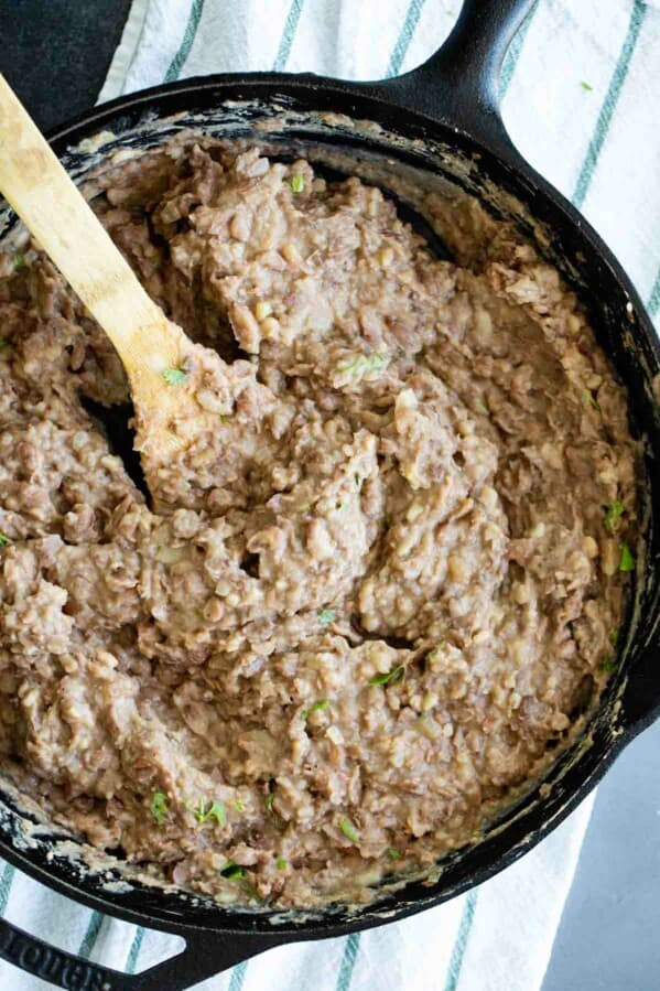 overhead view of refried beans in a cast iron skillet