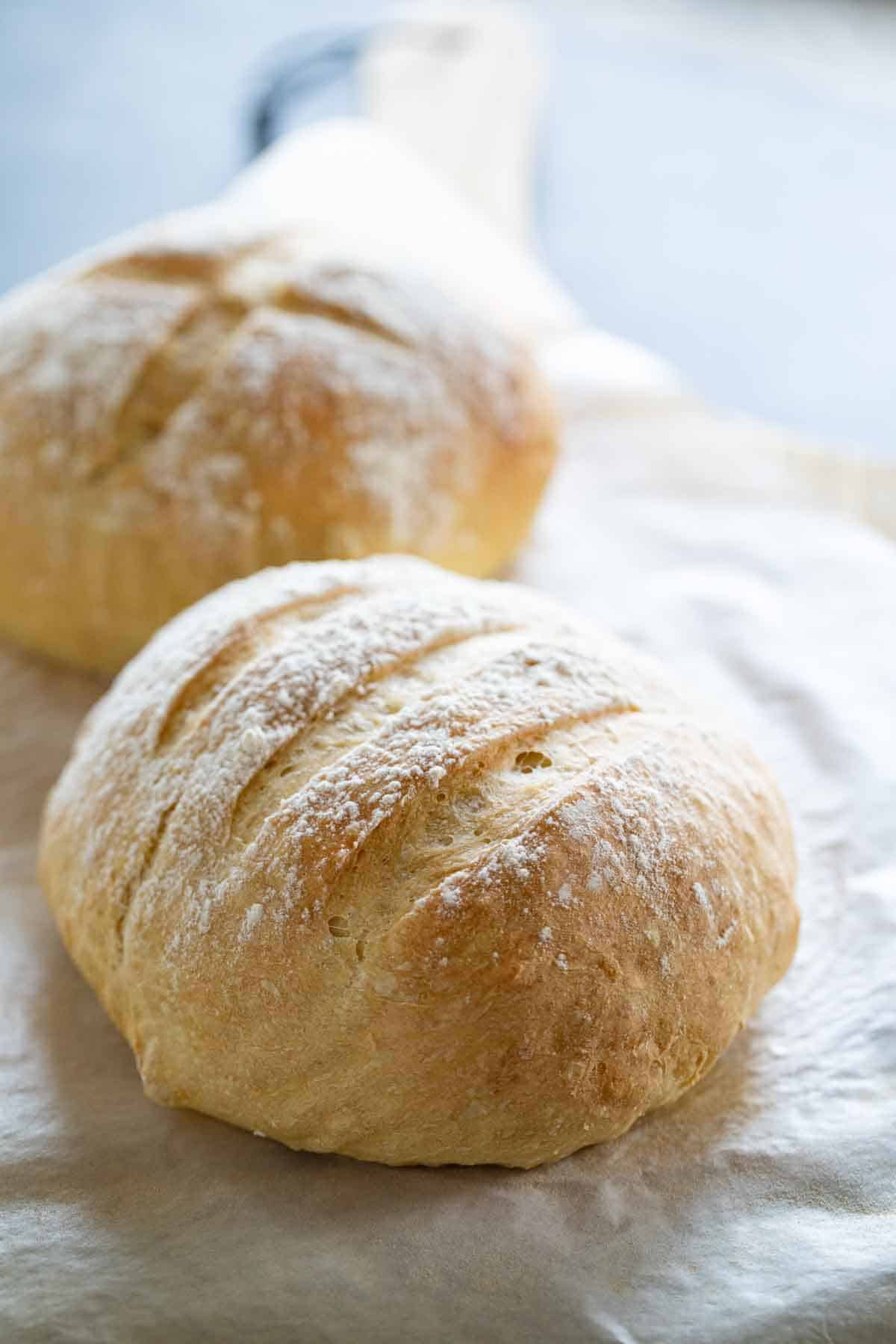 2 loaves of artisan bread on parchment paper