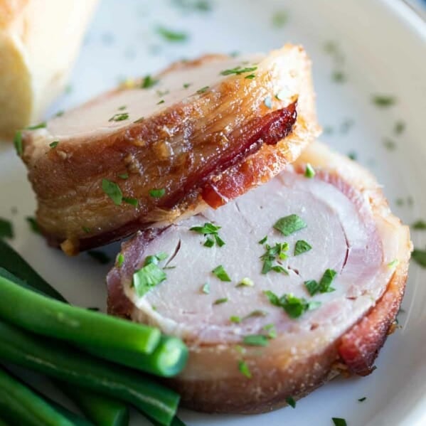 pork tenderloin wrapped in bacon on a plate