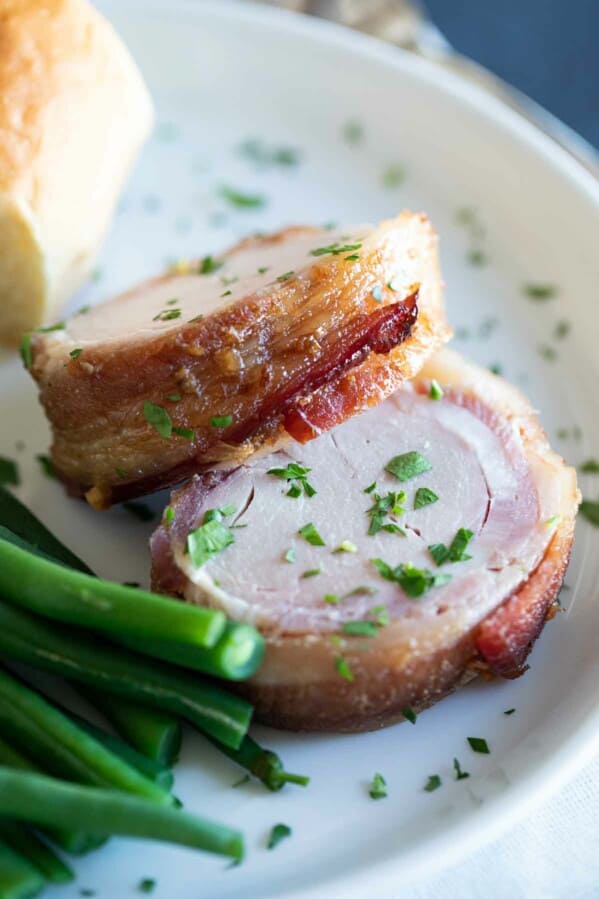 pork tenderloin wrapped in bacon on a plate