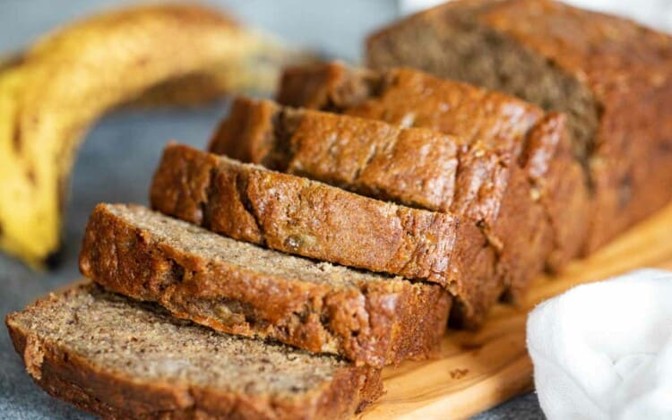 loaf of sliced banana bread on a cutting board