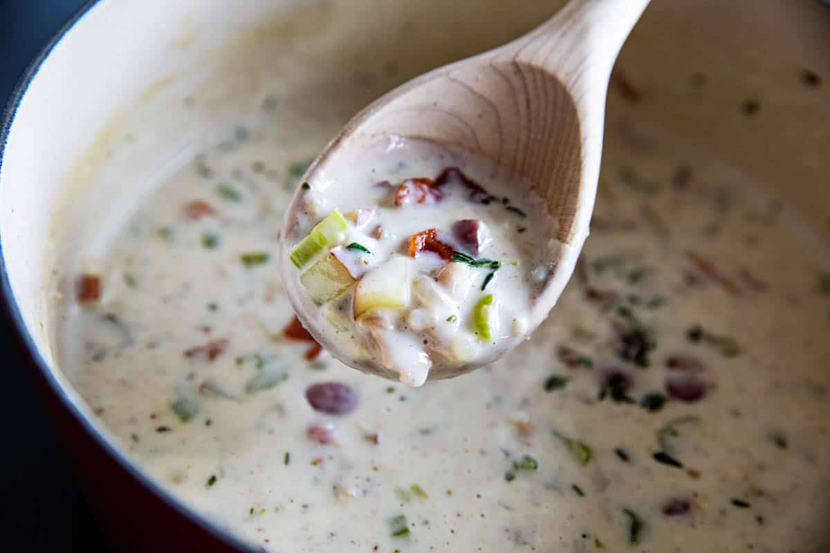 pot of clam chowder with a ladle full of soup