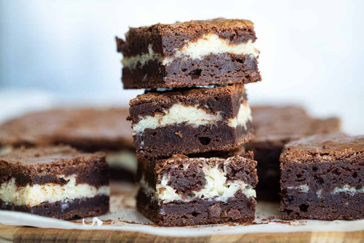 3 coconut filled brownies stacked on top of each other
