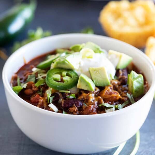 white bowl with crock pot chili with toppings