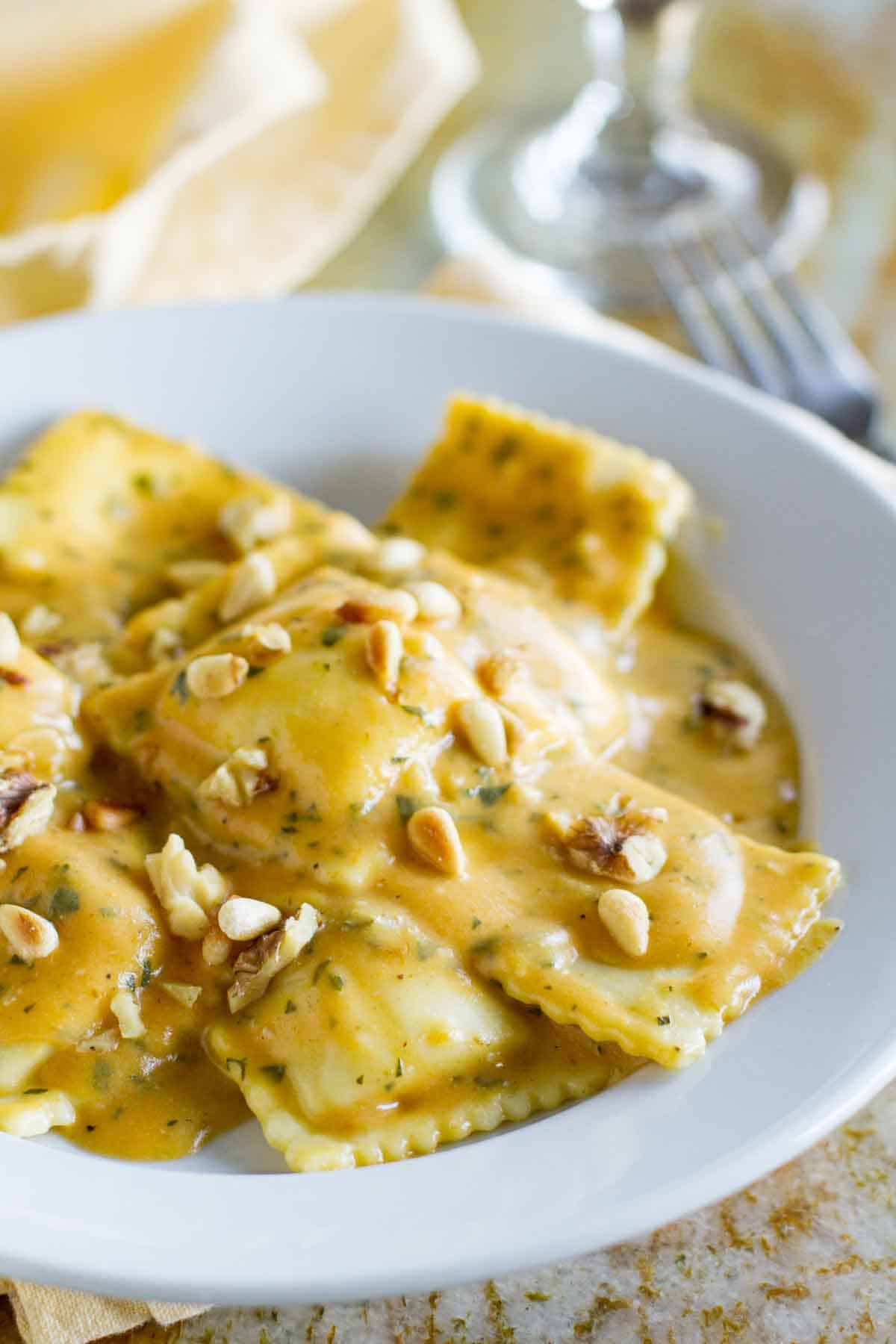 ravioli in a bowl topped with pumpkin pasta sauce