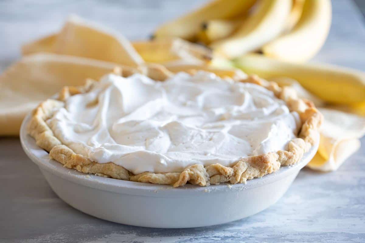 whole banana cream pie topped with whipped cream